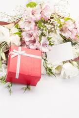 gift and flowers on white