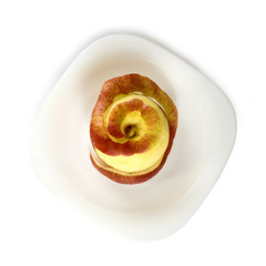 Isolated image of a ripe apple on a plate top view