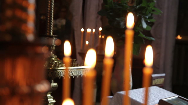 orange candles burn in the church 1080p