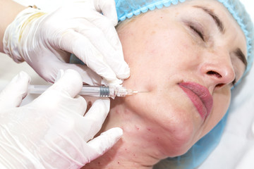 Cosmetic treatment with injection in a clinic