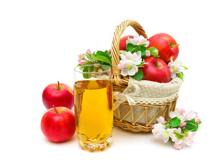 a glass of juice and a basket of apples on white background