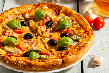 Pizza with bacon, olives and jalapeno pepper