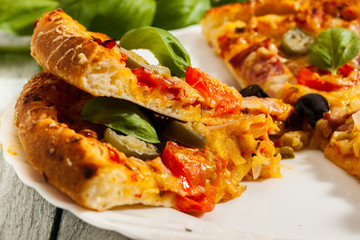 Pizza with bacon, olives and jalapeno pepper
