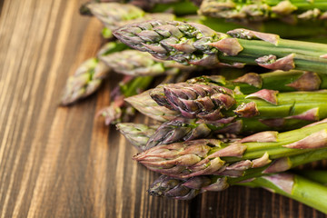 Bunch of young asparagus on wooden table