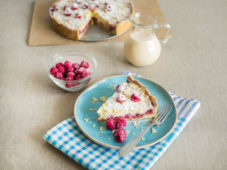 A piece of mascarpone pie with fresh raspberris and milk