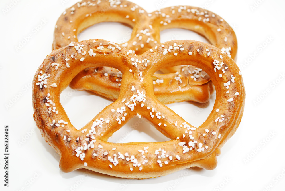 Wall mural Two Soft Baked Pretzels Isolated Over a White Background