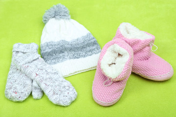 Winter cap, shoes and gloves,  on color background