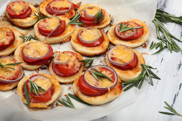 Small pizzas on baking paper close up