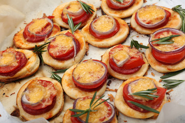 Small pizzas on baking paper close up