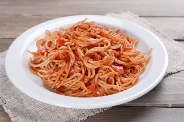 Pasta with tomato sauce on plate on table close-up