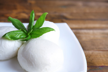 Tasty mozzarella cheese with basil