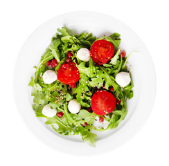 Green salad made with  arugula, tomatoes, cheese mozzarella