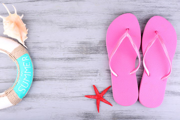 Bright flip-flops on color wooden background