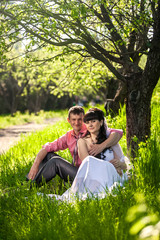 newly married couple hugging under tree at alley