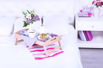 Fototapeta na wymiar Light breakfast and beautiful bouquet on bed