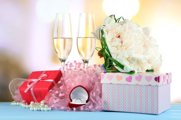 Beautiful wedding bouquet, gift box and wine glasses