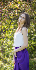 Girl in flowers of cherry