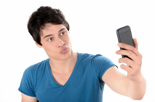 Man taking a kissing selfie photo with his smart mobile phone.