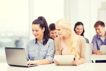 students with laptop, tablet pc and notebooks