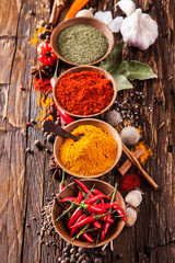 Various spices on wood