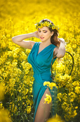 Fashion beautiful young woman in blue dress and yellow flowers