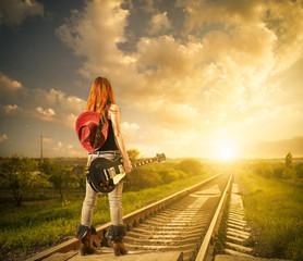 redhead woman with guitar at railway distance to sunset © arts