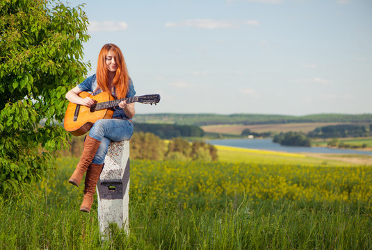 woman playing guitar at spring meadow