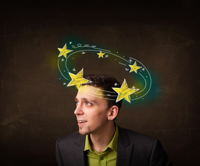 Young man with yellow stars circleing around his head