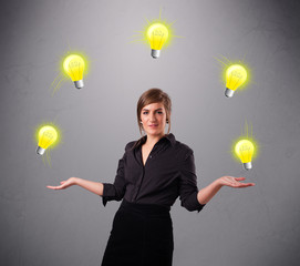 young lady standing and juggling with light bulbs