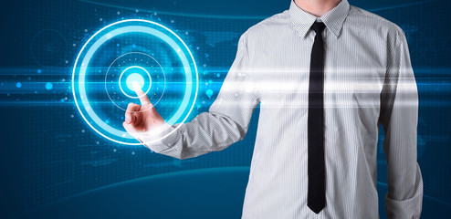 Businessman pressing high tech type of modern buttons