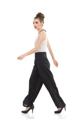 Obraz premium Walking fashion model. Side view.