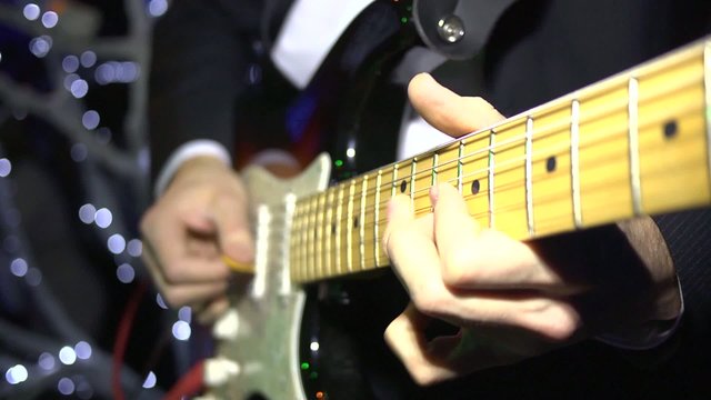 Fingers and solo guitar in action