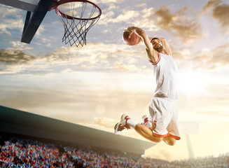 Basketball player in action on background of sky and crowd