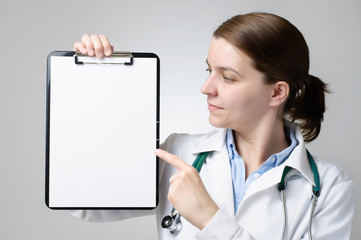 Doctor pointing at blank clipboard