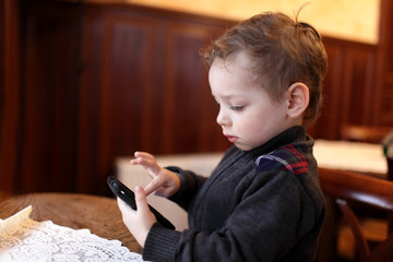 Kid playing on the smartphone