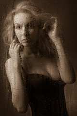 Beautiful girl in black lingerie for a wet glass 