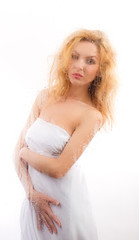 Fototapeta na wymiar Portrait of a girl in white cloth for wet glass