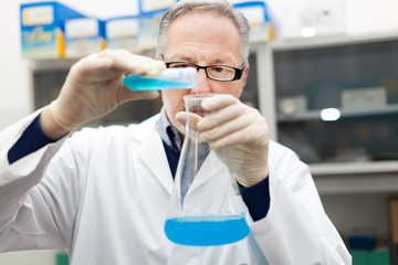 Scientist filling an Erlenmeyer flask
