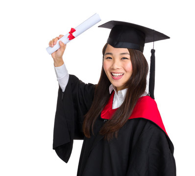 Happy graduate student girl in an academic gown with diploma