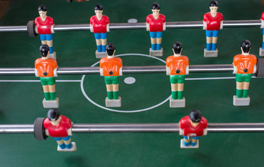 Table football game with red and orange players 