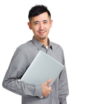 Confident Young Man Holding Laptop