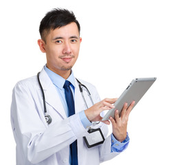 Doctor working on digital tablet