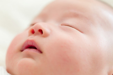 Peaceful baby lying on bed