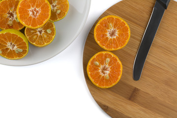 Sliced orange on wooden plate