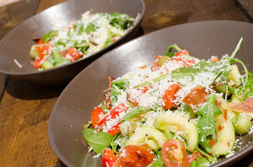 Arugula Salad with tomatoes, olives and parmesan