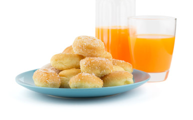 Mini sugary donuts in blue dish with orange juice