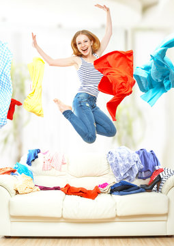 Funny girl with flying clothes jumping at home
