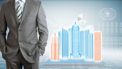 Businessman with high-tech skyscrapers and graphs