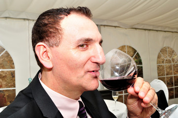 Man drinking red wine.
