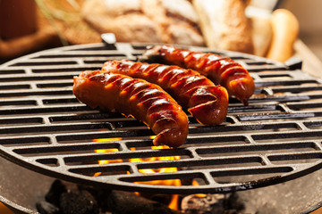 Grilling sausages on barbecue grill